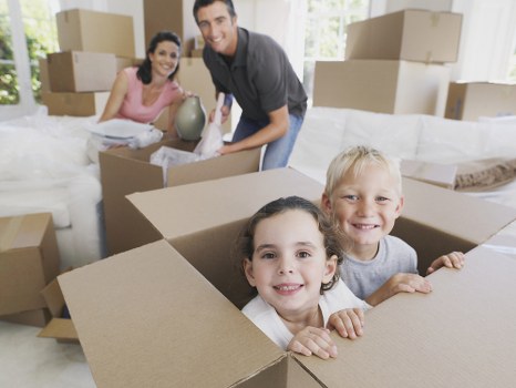 Mover carrying a sofa from a local townhouse or condo
