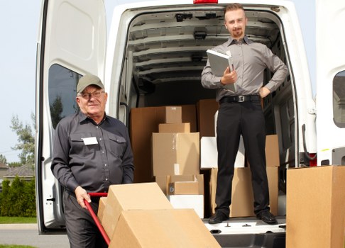 Greenwich Movers team sorting reusable moving items for recycling and charity donation