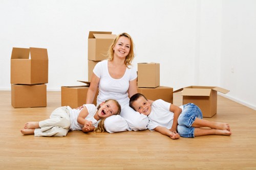 Experienced movers in Greenwich transporting furniture safely through a home doorway