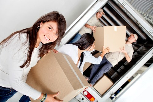 Packed office boxes and furniture ready for moving in Greenwich
