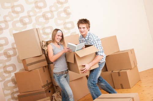 Local Greenwich movers handling furniture with protective wrapping